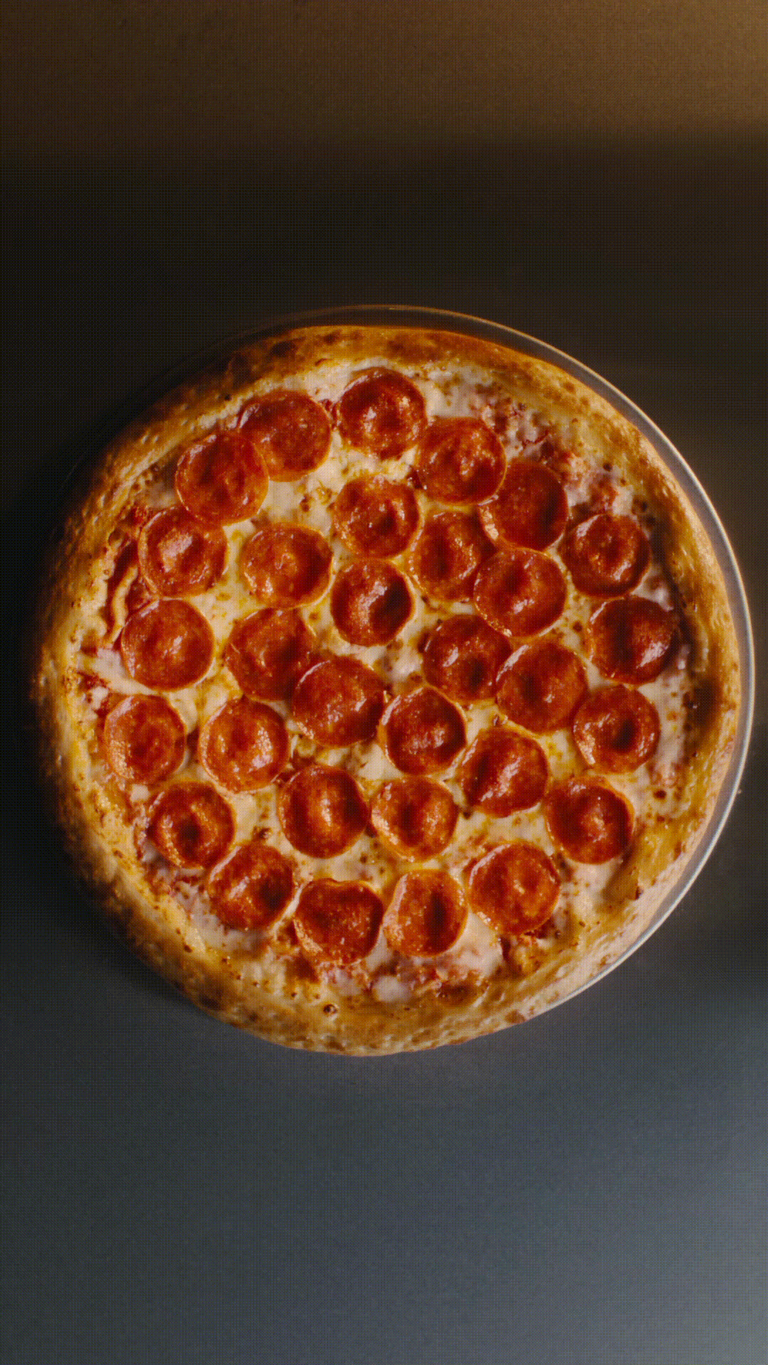 Croissant Pizza being flipped in the air