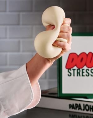 A hand squishing a dough stress ball