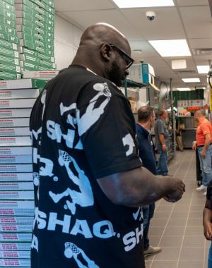 Shaq speaks with local youths at Papa Johns restaurant