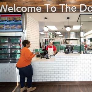 Customer picking up order from Papa Johns