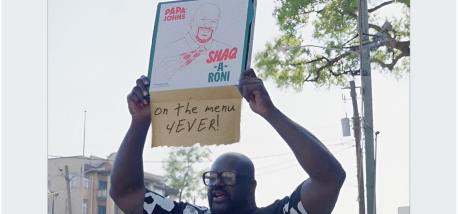 Shaquille O'Neal holding a Shaq-a-Roni box